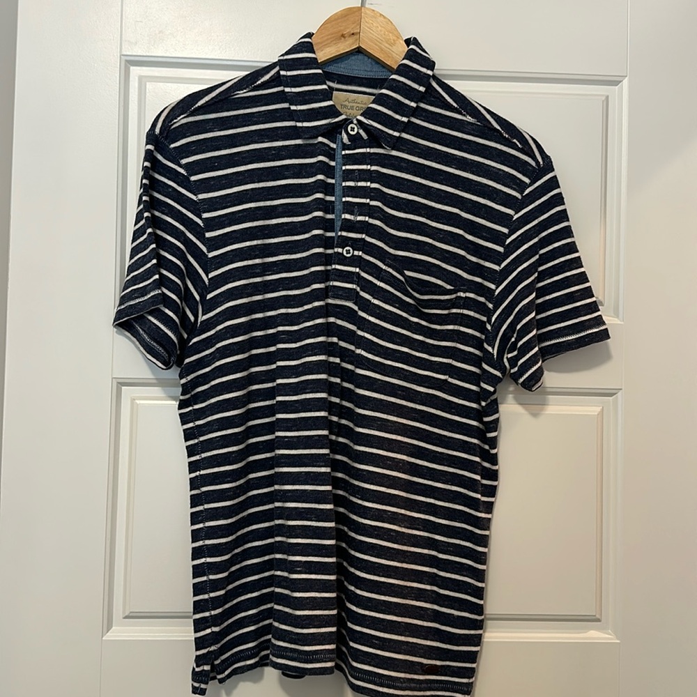 True Grit polo.  Dark blue with white stripe.  Size M